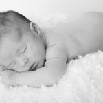 a brisbane baby snuggling on a lambs wool