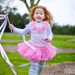 pinwheels and pearls a girl playing with a ribbon wand